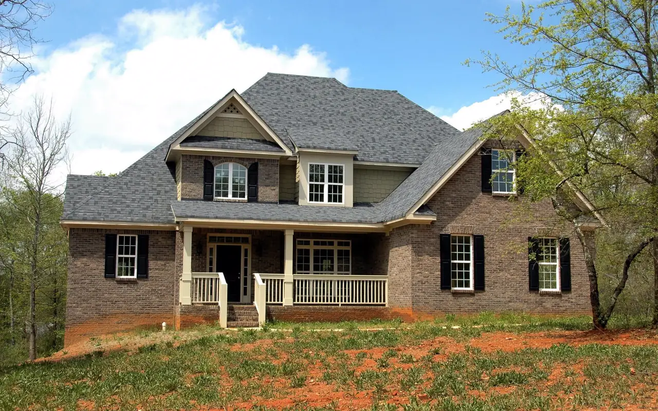 A two-story brick house on a quiet street.